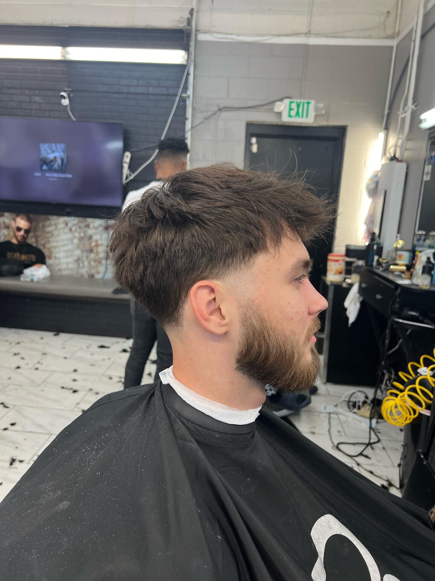 Textured low taper haircut and beard by The Fade Crew